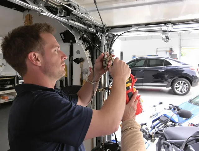 Bridgeport Garage Door Repair safety certified technician performing cable replacement in Bridgeport